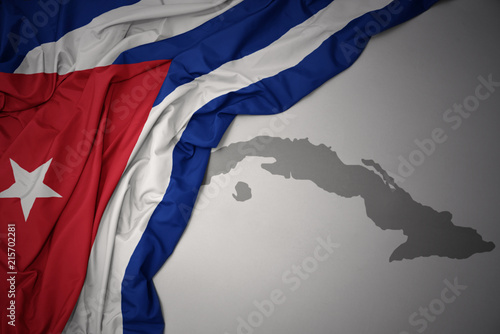 Photography waving colorful national flag and map of cuba.