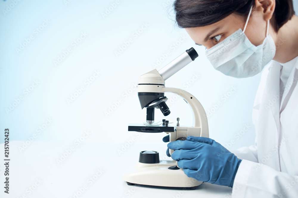 scientist looking through microscope scientist looking through microscope