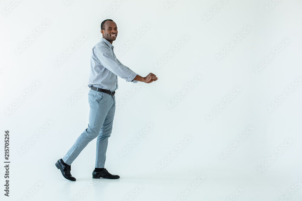 Positive afro american man holding the cart Positive afro american man holding the cart