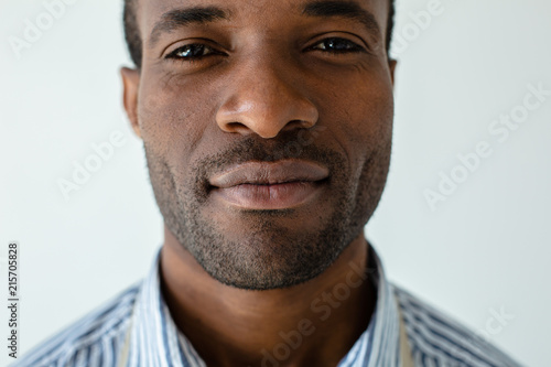 Confident afro americn man standing against white background