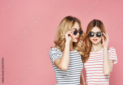 stylish girlfriends on a pink background women © SHOTPRIME STUDIO