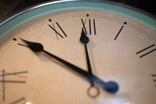 Wall clock showing ten minutes till midnight.