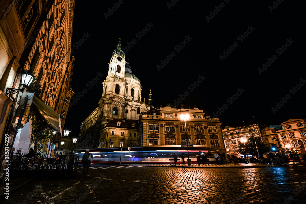 Obraz premium Prague, Czech Republic - October 11, 2017: Night view on ancient Church of Saint Nicholas is a Baroque church in the Lesser Town of Prague, Czech Republic