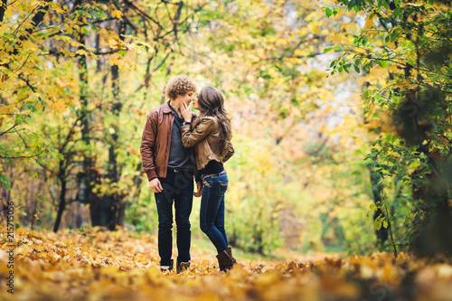 Loving couple kissing among beautiful autumn maples. © Marina Varnava
