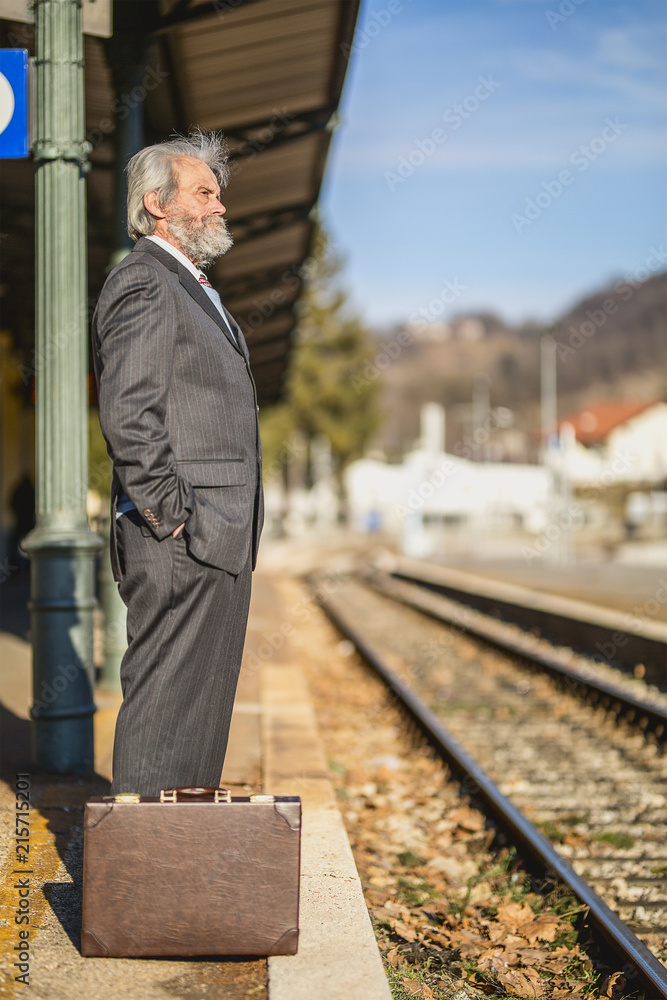 Senior businessman walking and Waits train