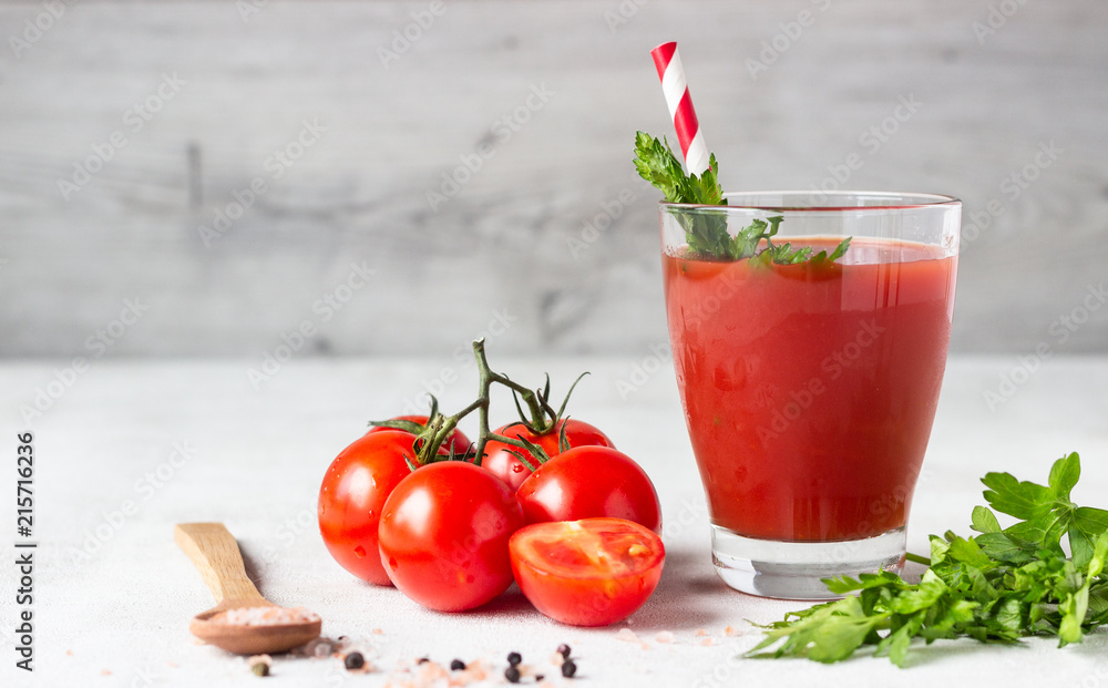 Tomato juice with fresh tomatoes, parsley, sea salt and pepper on light grey background. Vegetable drink. Tomato juice with fresh tomatoes, parsley, sea salt and pepper on light grey background. Vegetable drink.