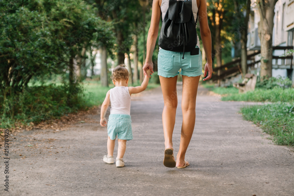 Mother with little daughter walking in the park Mother with little daughter walking in the park