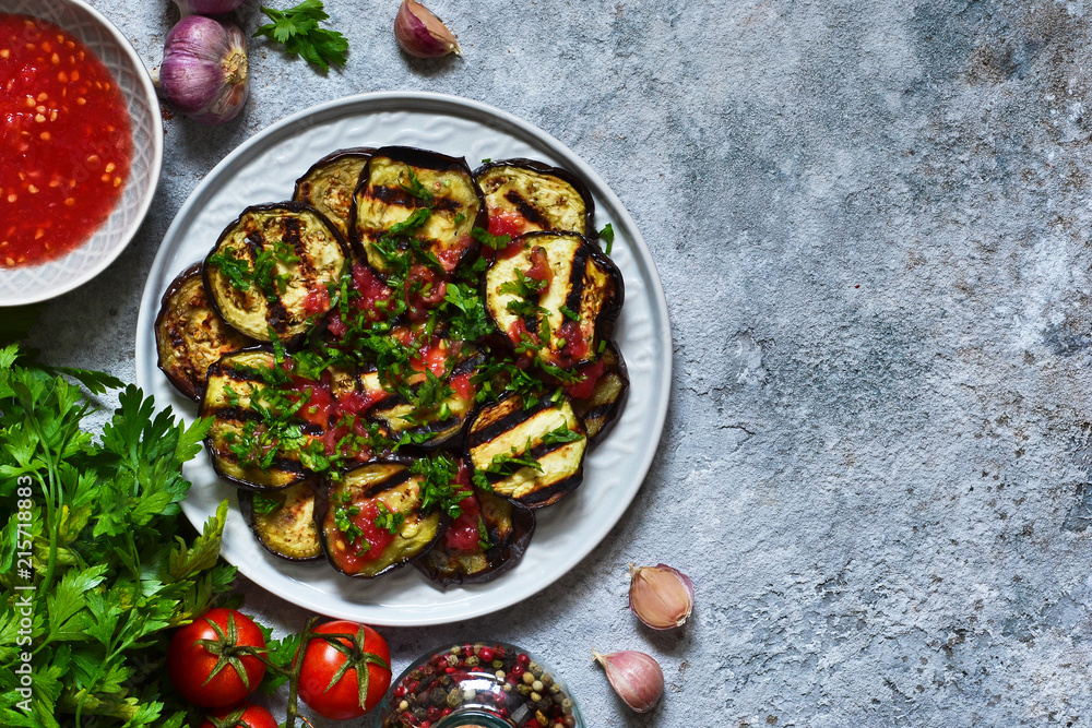 Spicy eggplant with tomato sauce and cilantro. Grilled eggplant.