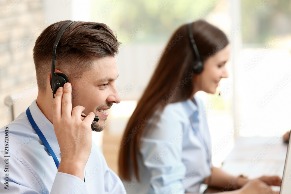 Technical support operators with headsets at workplace Technical support operators with headsets at workplace