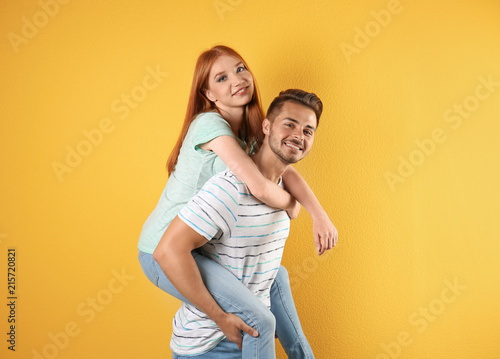 Young couple in stylish jeans on color background © New Africa