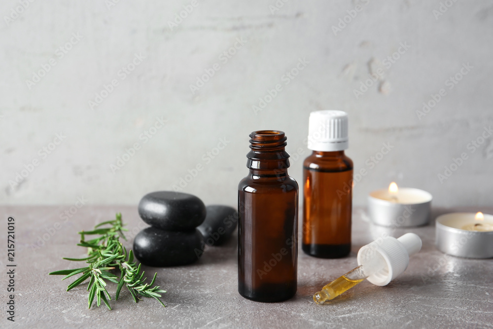 Spa composition with fresh rosemary oil on table Spa composition with fresh rosemary oil on table