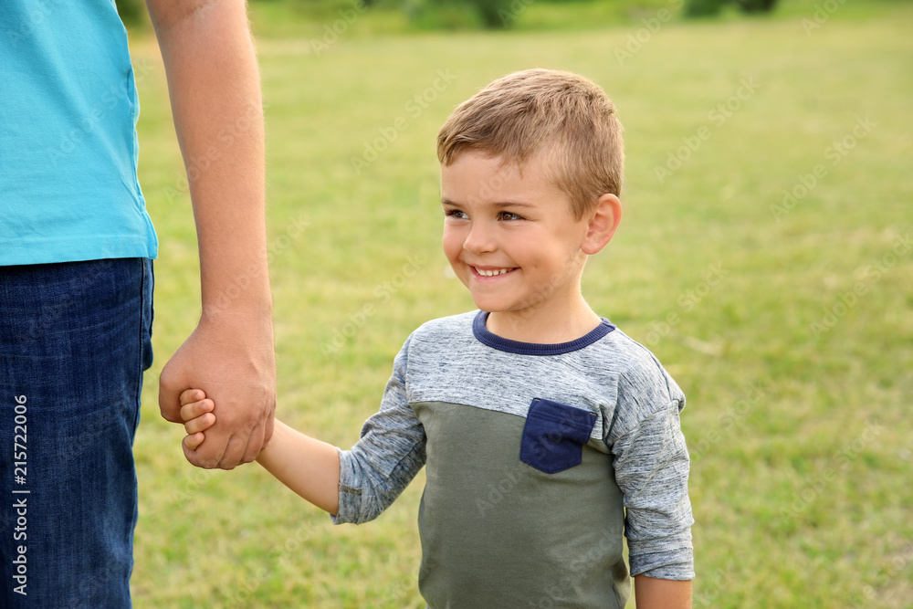 Man holding hands with his child outdoors. Happy family Man holding hands with his child outdoors. Happy family