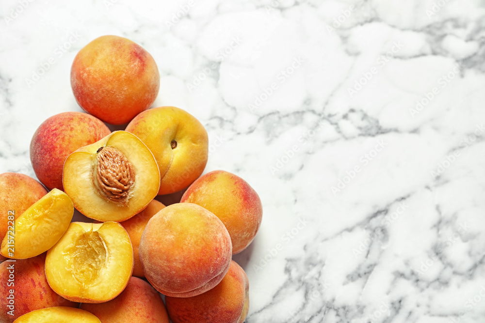 Pile of delicious ripe peaches on marble background, top view Pile of delicious ripe peaches on marble background, top view