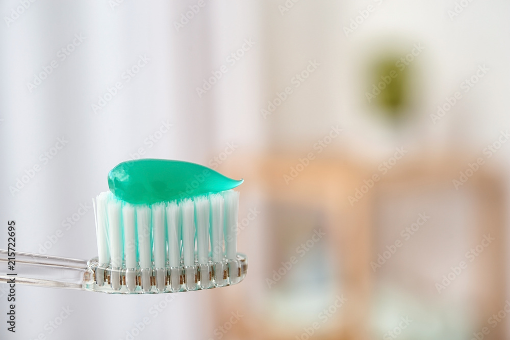 Toothbrush with paste on blurred background, closeup Toothbrush with paste on blurred background, closeup