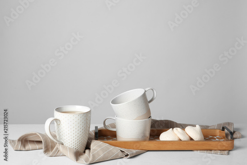 Ceramic tea set and tasty meringues on table