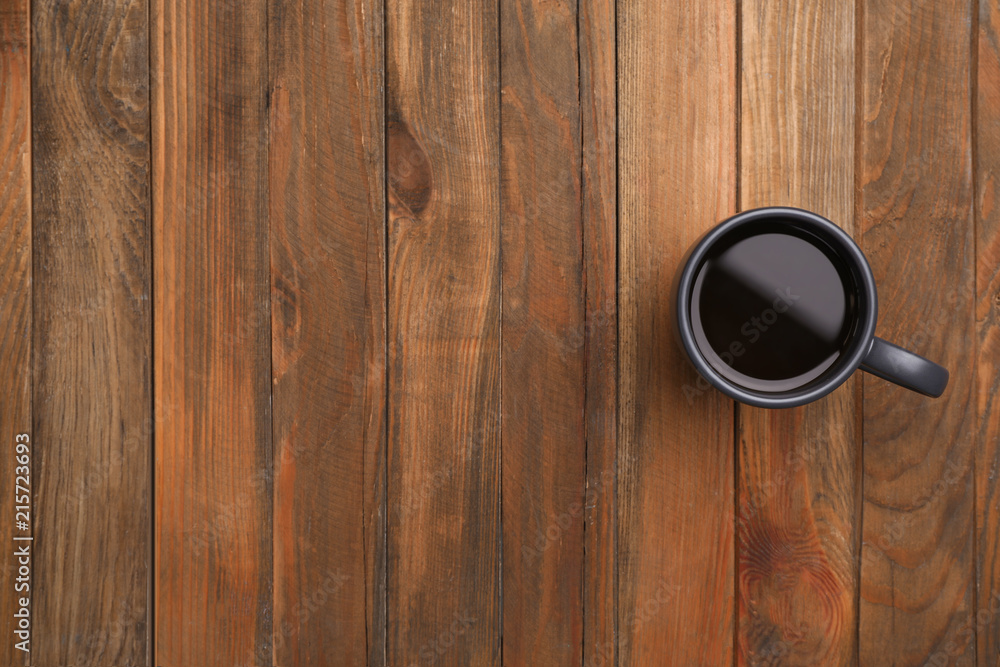 Ceramic cup with hot aromatic coffee on wooden background, top view Ceramic cup with hot aromatic coffee on wooden background, top view