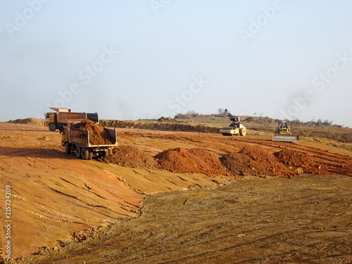 Heavy machinery doing earthwork at the construction site. Works carried out before building construction starts to get required levels. 