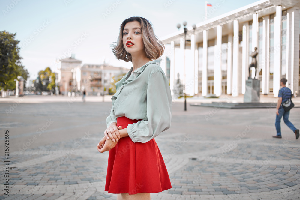 woman in a red skirt in the city