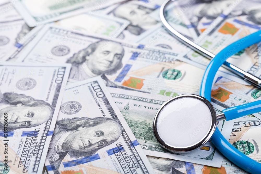 Stethoscope on dollar banknotes background Stethoscope on dollar banknotes background