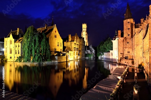 Evening view of the illuminated medieval canals of Bruges, Belgium