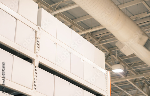 White Package Boxes on the shelves in the large warehouse