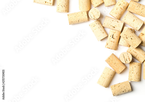 Heap of unused, new, brown natural wine corks on white background, flat lay top view