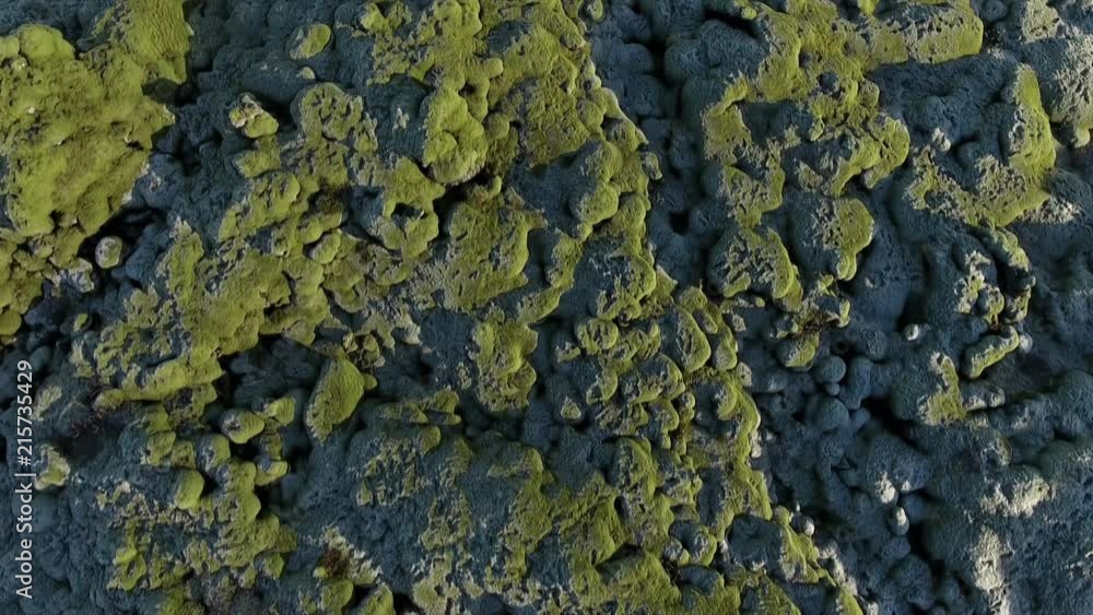 Flying over the rock and moss covered landscape of Iceland Flying over the rock and moss covered landscape of Iceland