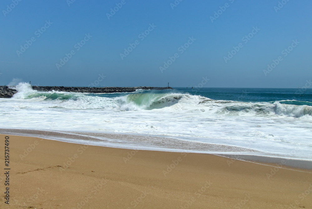 waves crashing on a sandy beach 