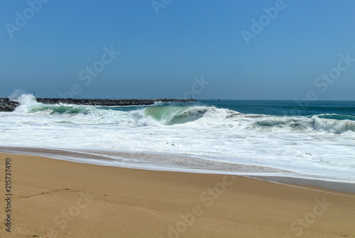 waves crashing on a sandy beach 