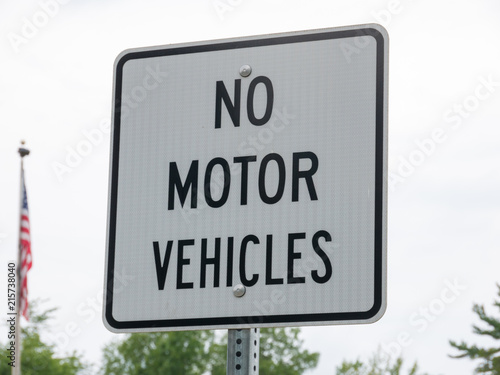 No motor vehicle sign in park with a USA flag on background photo