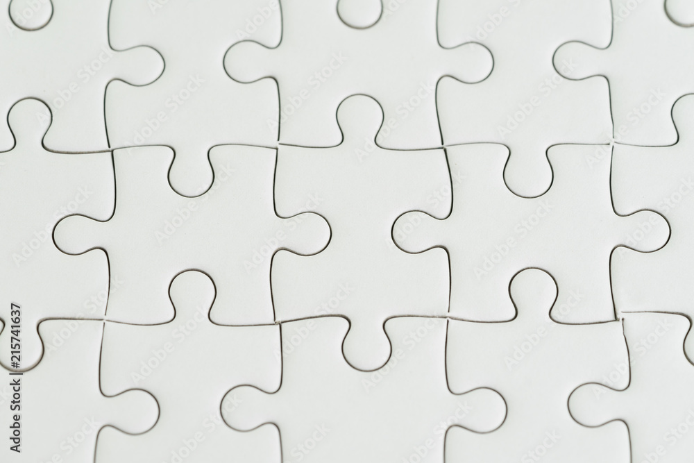 Close-up shot of white paper jigsaw puzzle using as background or problem solving and business solutions concept Close-up shot of white paper jigsaw puzzle using as background or problem solving and business solutions concept