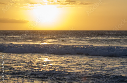 A surfer watching the Sunset