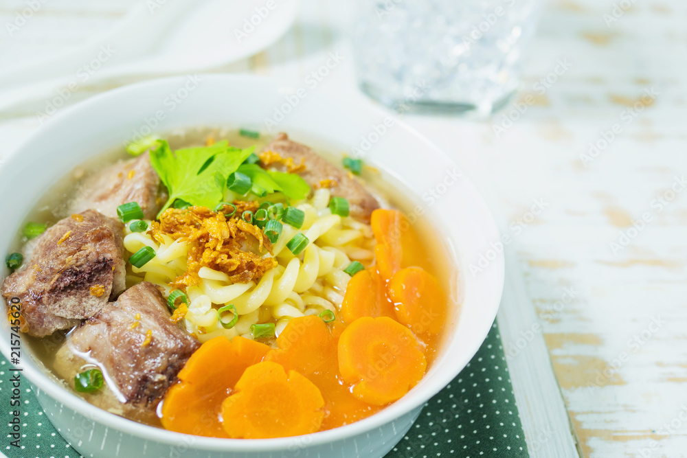 Macaroni soup with pork and carrot on white wooden table - delicious and healthy food concept Macaroni soup with pork and carrot on white wooden table - delicious and healthy food concept