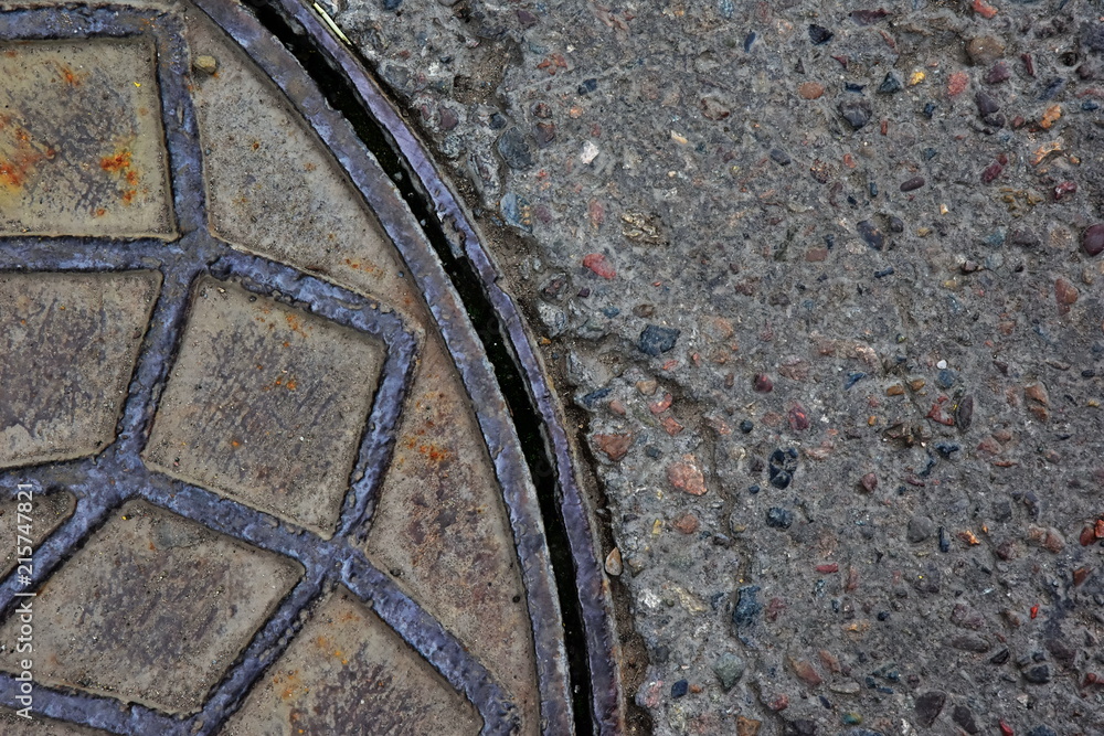 Urban background. Segment of the sewer hatch and asphalt covering Urban background. Segment of the sewer hatch and asphalt covering