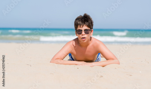 Young child on holidays at the beach scared in shock with a surprise face, afraid and excited with fear expression