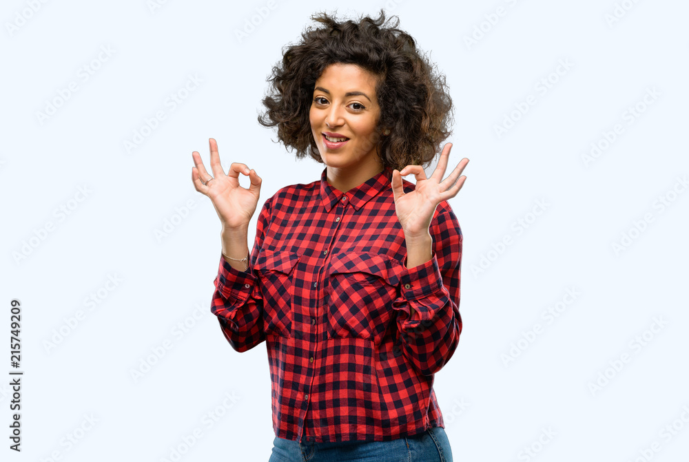 Beautiful arab woman doing ok sign gesture with both hands expressing meditation and relaxation Beautiful arab woman doing ok sign gesture with both hands expressing meditation and relaxation