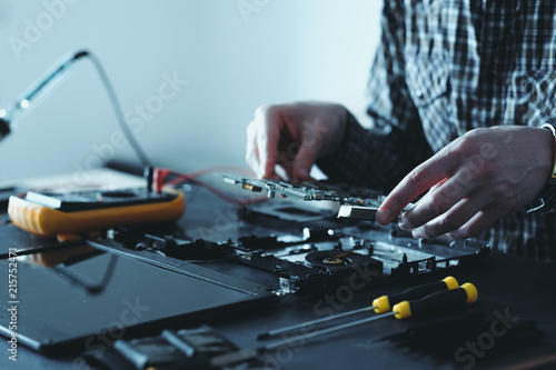 computer upgrade. technology development. microelectronics scientific innovation concept. engineer disassembling laptop