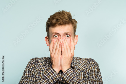 unbelievable news. terrified shocked dumbfounded desperate alarmed dismayed man in distress. portrait of a young guy on light background. emotion facial expression and feelings concept.