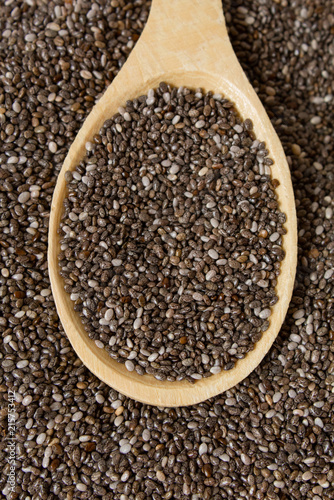 Healthy Chia seeds in a wooden spoon on a wooden table