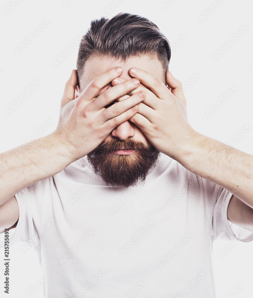 Fototapeta premium young bearded man closing his eyes over white background
