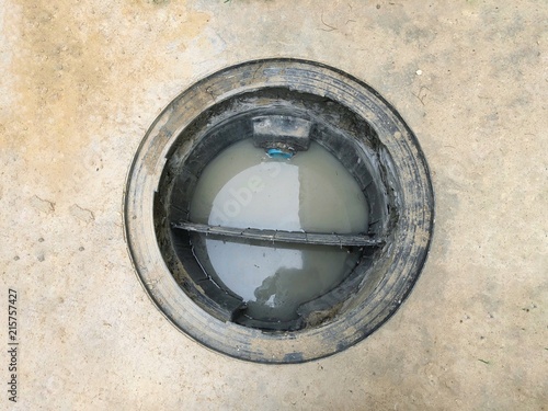A hole of grease trap with the drain system around the house.