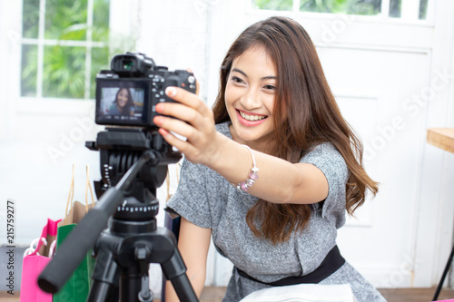 Asian attractive girl checking to camera for record video. Woman using social media to promote her business.