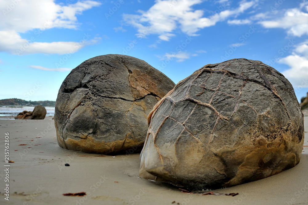 Stone balls on a sandy beach in New Zealand