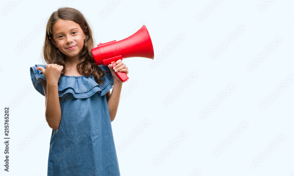 Brunette hispanic girl holding red megaphone pointing and showing with thumb up to the side with happy face smiling Brunette hispanic girl holding red megaphone pointing and showing with thumb up to the side with happy face smiling