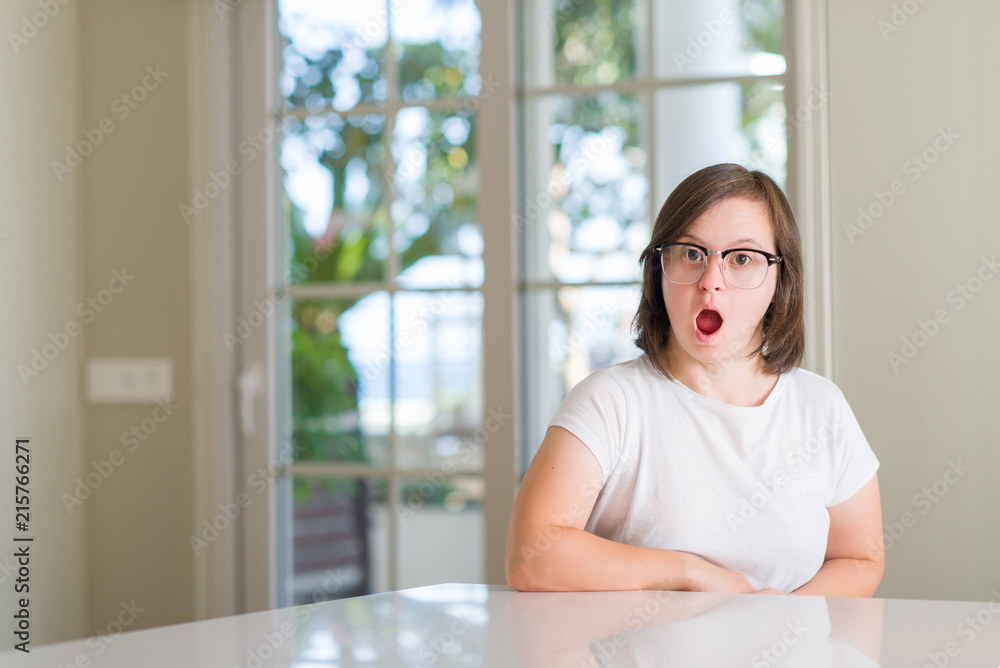 Down syndrome woman at home scared in shock with a surprise face, afraid and excited with fear expression Down syndrome woman at home scared in shock with a surprise face, afraid and excited with fear expression