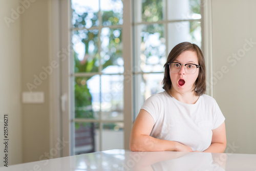 Free Download Down syndrome woman at home scared in shock with a surprise face, afraid and excited with fear expression - GFXLoad