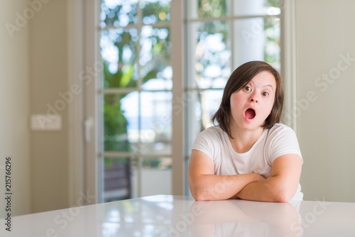 Down syndrome woman at home afraid and shocked with surprise expression, fear and excited face. Free Download Down syndrome woman at home afraid and shocked with surprise expression, fear and excited face. - GFXLoad