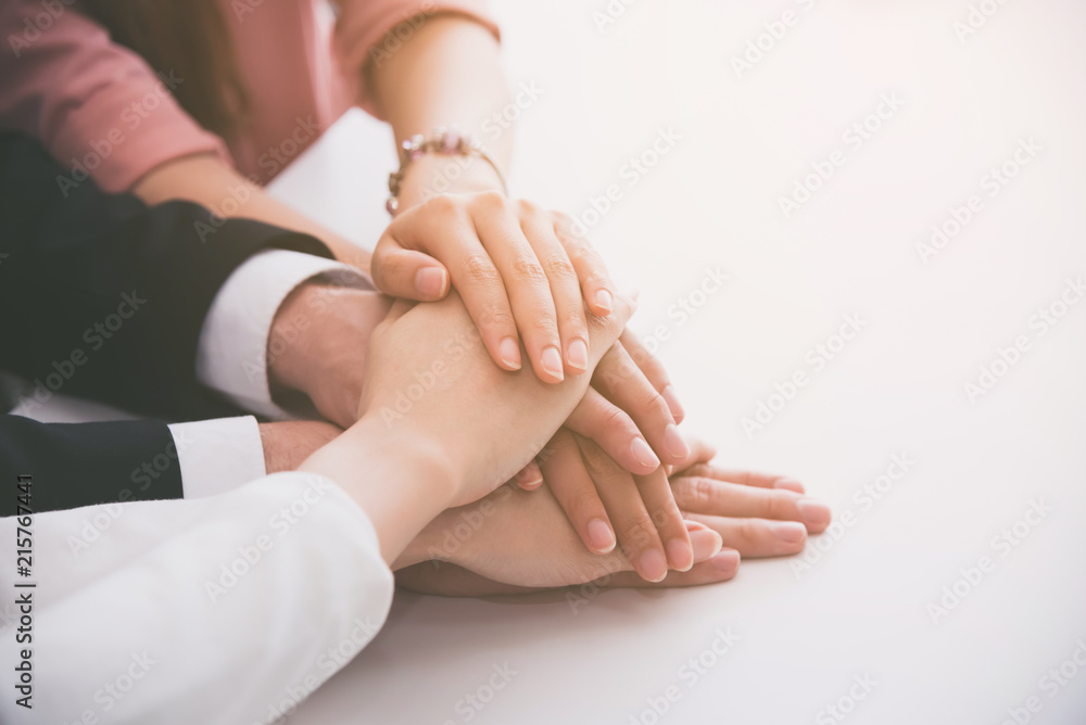business people team showing unity with their hands together expose the power of work