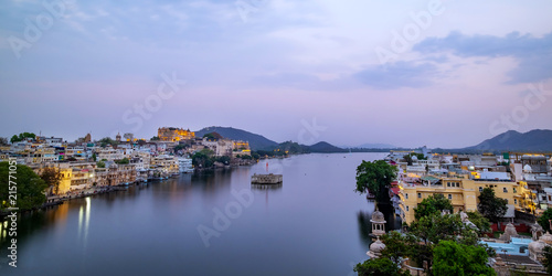 Udaipur city at lake Pichola in the evening, Rajasthan, India. View of City palace reflected on the lake. © tanarch