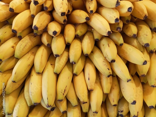 Freshly ripe yellow bananas stacked on each other.